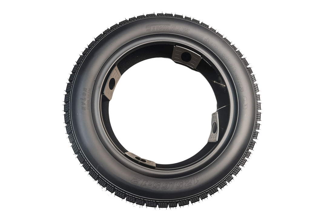 EMMO installed 125/65-12 scooter tire on alloy wheel featuring low-resistance surface design and wide contact patch ideal for urban paths and gentle park-road cruising in winter