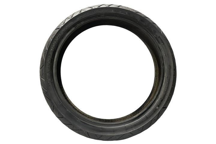 Angled profile of narrow motorcycle tire displaying shallow arc design and even tread spacing, crafted for efficient road grip, low friction, and consistent high-speed stability.